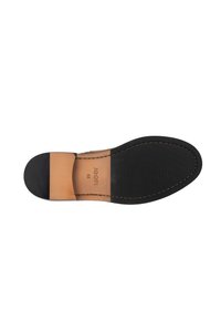 Suela de zapato de cuero negro con un acento de cuero marrón. Presenta bordes cosidos y el nombre de la marca en relieve "JOOP!" con tamaño "42".