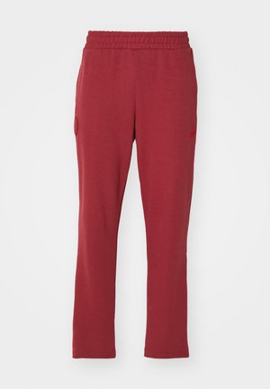 Rote Baumwoll-Jogginghosen mit elastischem Bund, geradem Schnitt, seitlichen Taschen und dezentem Logo auf dem linken Bein.