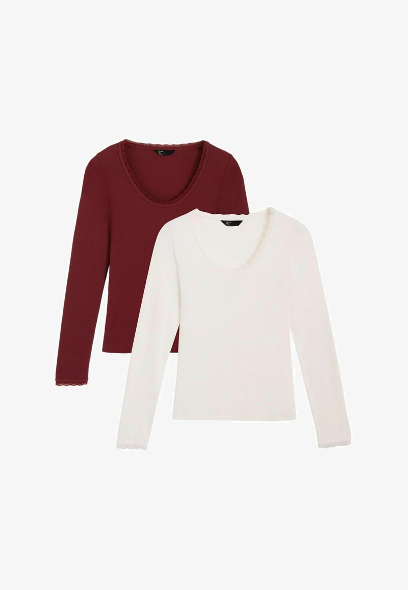 Dwa długie topy z długim rękawem: jeden w kolorze bordowym z dekoltem i mankietami o falowanym wykończeniu, drugi w białym kolorze z podobnymi detalami. Miękki, dopasowany materiał.