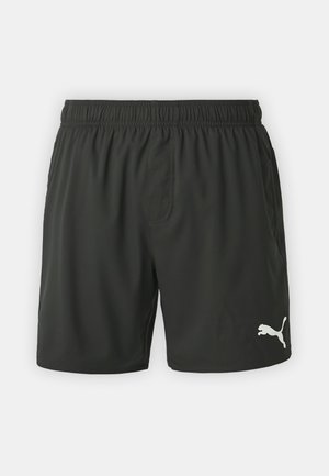 Pantaloni sportivi neri con elastico in vita, realizzati in tessuto leggero. Presentano il logo Puma bianco sul lato inferiore destro.