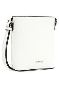 White leather crossbody bag with black trim, square shape, adjustable strap, and a silver logo accent at the bottom. Textured surface.