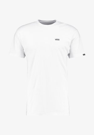 T-shirt bianco a maniche corte in cotone, con un piccolo logo Vans nero sul petto e un'etichetta nera sulla manica sinistra.