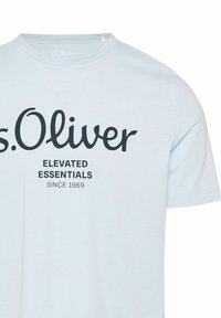 Light blue cotton t-shirt with a round neckline and short sleeves. Features black printed text: “s.Oliver ELEVATED ESSENTIALS SINCE 1969.”