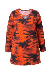 Long-sleeve tunic featuring a vibrant orange and black abstract pattern, v-neck with layered detail, and soft fabric texture.