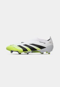 White and neon yellow Adidas Predator football boot with black stripes and cleats, side view on a white background.