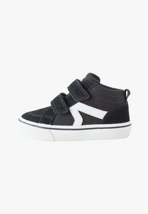 Schwarzer Kleinkind-Sneaker mit weißer Sohle, zwei Klettverschlüssen und weißem Zickzackmuster an der Seite.