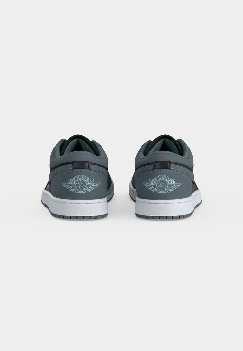 Paar graue und schwarze Low-Top Air Jordan Sneakers aus der Rückansicht, mit weißen Sohlen und geflügeltem Basketball-Logo an den Fersen.