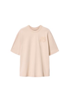 Beige übergroßes T-Shirt mit kurzen Ärmeln, rundem Halsausschnitt und dezenten erhabenen "AS"-Buchstaben auf der linken Brustseite.