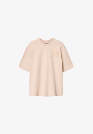 Beige übergroßes T-Shirt mit kurzen Ärmeln, rundem Halsausschnitt und dezenten erhabenen "AS"-Buchstaben auf der linken Brustseite.