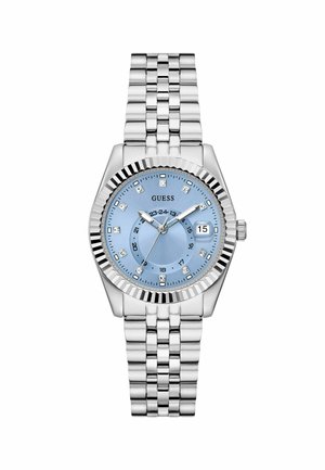 Montre argentée avec un cadran bleu, des marqueurs d'heure ressemblant à des diamants et un affichage de la date, dotée d'un bracelet métallique à maillons et d'une lunette crantée.