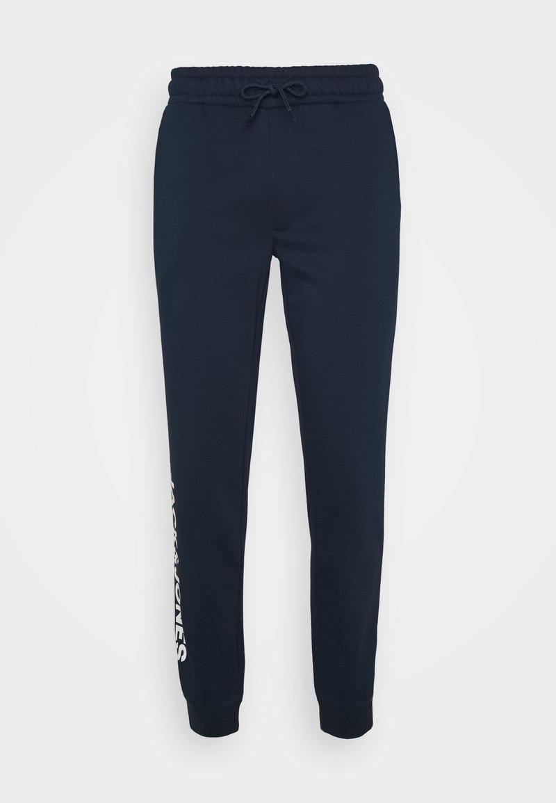 Navy blue joggers made of soft cotton blend fabric, featuring a drawstring waist, cuffed ankles, and a white logo printed on the side.