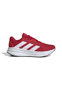 Red athletic shoes with a mesh upper, featuring three white stripes on the side, a cushioned sole with "CLOUDFOAM" branding, and red laces.