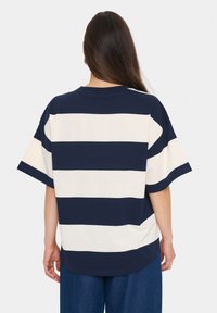 Navy and cream striped cotton t-shirt with a relaxed fit, short sleeves, and a rounded hem. Seam detailing is visible at the shoulders.