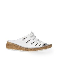 White leather slide sandals featuring multiple cut-out details, a cork midsole, and a textured white outsole.