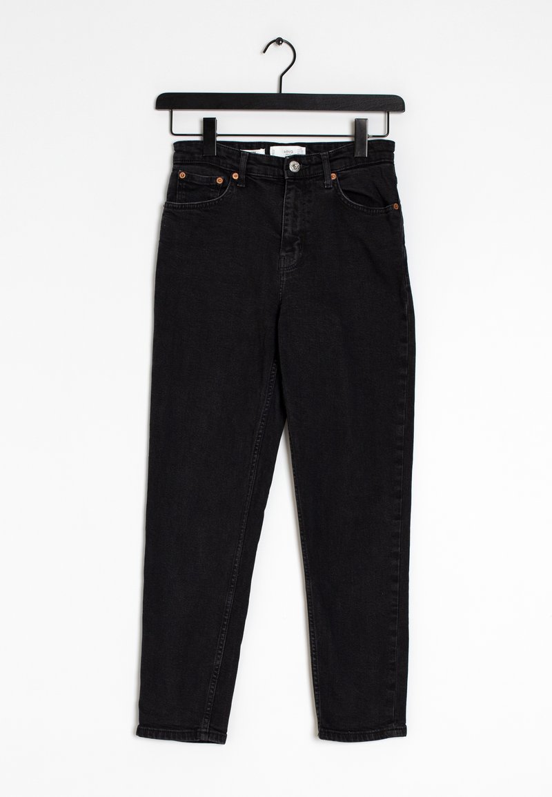 Jean noir taille haute suspendu sur un cintre en bois noir contre un fond blanc, avec des poches avant et une fermeture à bouton.