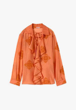 Blusa arancione a maniche lunghe con fronte arricciato, scollo con laccio e motivi floreali testurizzati sparsi su maniche e corpo.