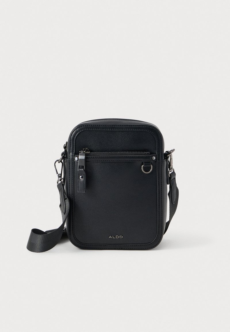 Petit sac bandoulière noir compact avec poche zippée à l'avant, ferrures argentées, sangle réglable et logo ALDO sur un fond uni.