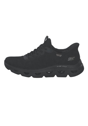 Schwarzer Skechers Glide-Step Sportschuh mit Schnürdesign und gepolsterter Sohle, die sichtbare Hohlkammern zur Stoßdämpfung aufweist.