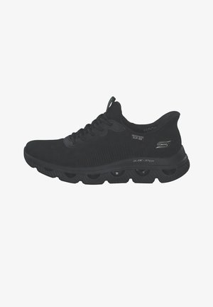 Black Skechers Glide-Step athletic shoe with lace-up design and cushioned sole featuring visible hollow pods for shock absorption.