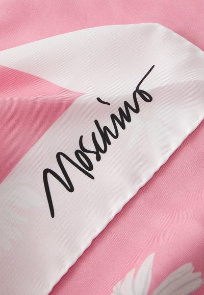 Pink fabric featuring a geometric design with sharp angles, smooth texture, and a prominent black Moschino signature.