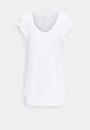 Biała bluzka z krótkim rękawem, z dekoltem w kształcie litery V i marszczeniami przy ramionach oraz u dołu. Wykonana z miękkiego, lekkiego materiału.