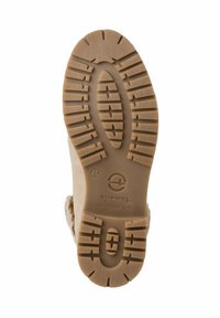 Brun gummiyttersida med ett texturerat greppmönster, med rundade kanter och en präglad logotyp i mitten. Designad för hållbarhet.