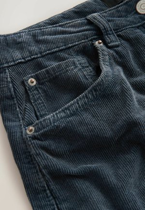 Dark blue corduroy pants featuring a textured fabric, five-pocket design, silver-tone hardware, and sewn detailing along the seams.