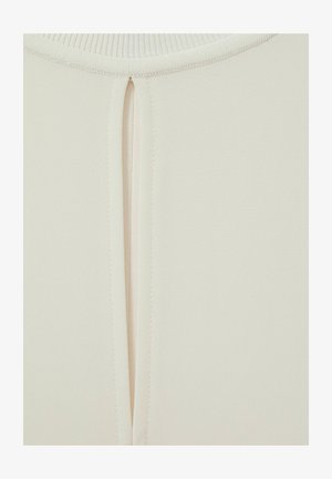 Heledbeez top, millel on tekstuuriga kangas, ümmargune kaelus ja keskne lõhe koos puhta õmblusega servadel.