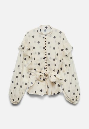 Cremefarbene Bluse mit schwarzen Punkten, Rüschendetails, herzförmigen Knöpfen, langen Puffärmeln und einer Taillenschleife.