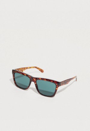 Sunglasses with a tortoiseshell pattern frame, square shape, green lenses, and slender temples. Durable plastic construction.