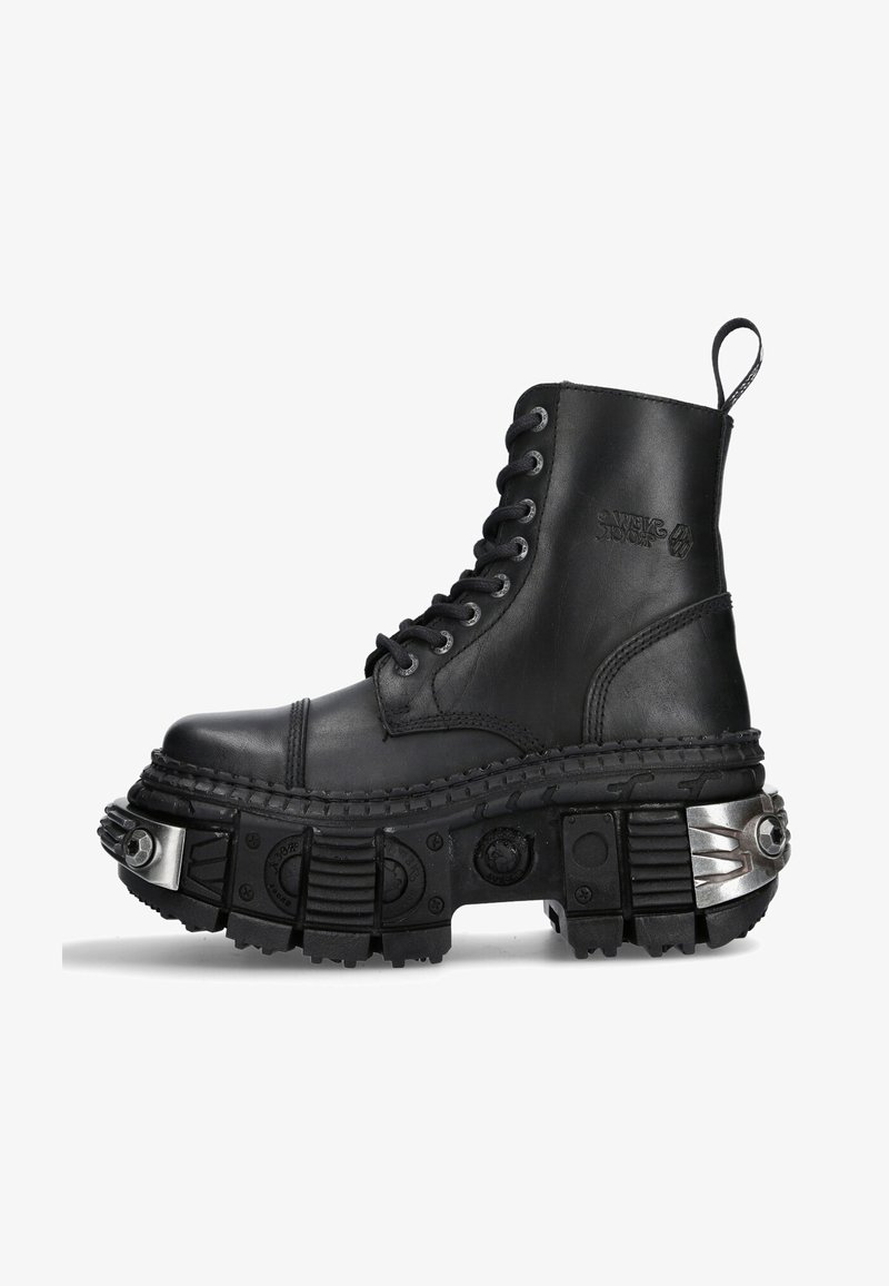 Black leather combat boot with high top, round toe, thick textured sole, silver hardware accents, and distinctive tread pattern.