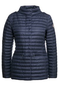 Navy blue quilted jacket with stand collar, zippered pockets, and logo patch on the sleeve.