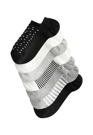 Eight pairs of low-cut socks in black, white, and gray. Patterns include polka dots, stripes, and solid colors, with varied textures.