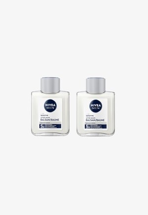 Two clear glass bottles of Nivea Men Sensitive After Shave Balm. Each has a silver cap and a label with blue and white text, indicating use and benefits.