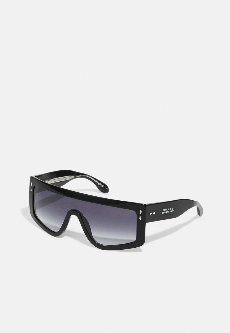 Black oversized sunglasses with a gradient lens. Features a thick frame, flat top edge, and rounded bottom. Notable brand logo on arm.