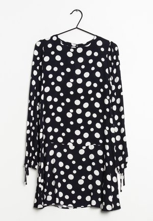 Navy dress with long sleeves, white polka dots, round neckline, and drawstring accents at the cuffs. Soft fabric and relaxed fit.