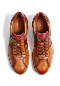 Baskets en cuir marron avec une texture lisse, des accents bordeaux sur la languette, et un design classique à lacets avec des rayures contrastantes.