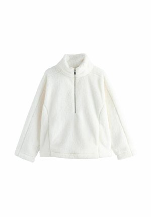 Balts šķiedras džemperis ar augstu apkakli, pusi rāvējslēdzēja un garām piedurknēm. Mīksta struktūra, brīva piegriezuma un bez redzamām rakstām vai akcentiem.