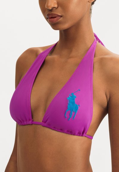Purple bikini top with halter neck design, featuring a blue embroidered horse logo, textured fabric, and gathered detailing at the bottom.