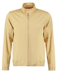 Lys beige jakke med opretstående krave, fuld frontlynlås og to sidelommer. Glat stof med elastiske manchetter og kant.