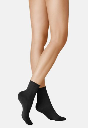 Schwarze Knöchelsocken aus weichem Material mit glatter Textur, die ein schlichtes Design und einen bequemen Bund ohne Muster oder Akzente aufweisen.