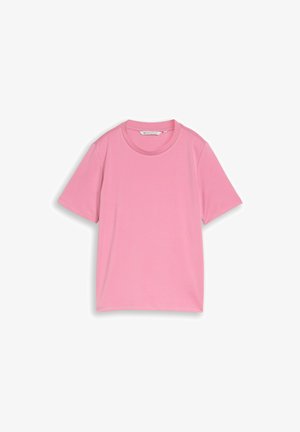 T-shirt uni rose à manches courtes et col rond, posé à plat avec l'étiquette de col visible.