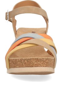 Sandalia beige con suela de corcho y tiras multicolores en naranja, amarillo y azul. Cuenta con una correa en el tobillo y un tacón plano.