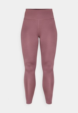 Lilla høyt liv leggings laget av elastisk, glatt stoff med sømløst design og ingen synlige sømmer på beina.