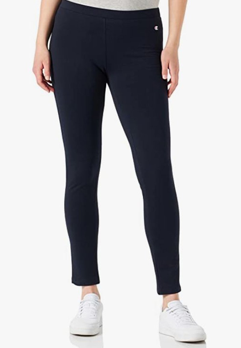 Navy színű leggings, rugalmas anyagból készült, testhezálló fazonú, bokáig érő hosszúságú, egy kis logóval a derékrészen és sima textúrával.