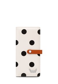 Black polka dots on a cream background, leather wallet with a brown strap and button closure, featuring a silver logo accent at the bottom.