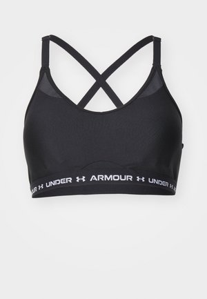 Crni sportski grudnjak s podešivim kopčama u obliku križa, izrađen od glatke tkanine. Ima bijelu traku s logotipom "UNDER ARMOUR" na dnu.