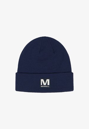 Navy blue knit beanie with a folded brim and a rectangular Merrell logo patch displaying a white "M." Smooth texture, warm material.