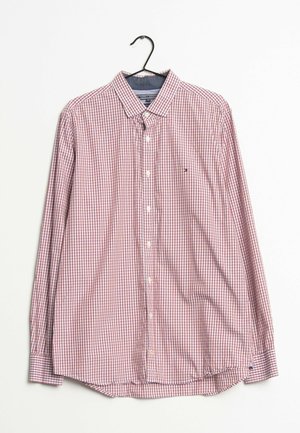 Langärmliges Hemd mit rot-weiß kariertem Muster, das an einem schwarzen Kleiderbügel vor weißem Hintergrund hängt.