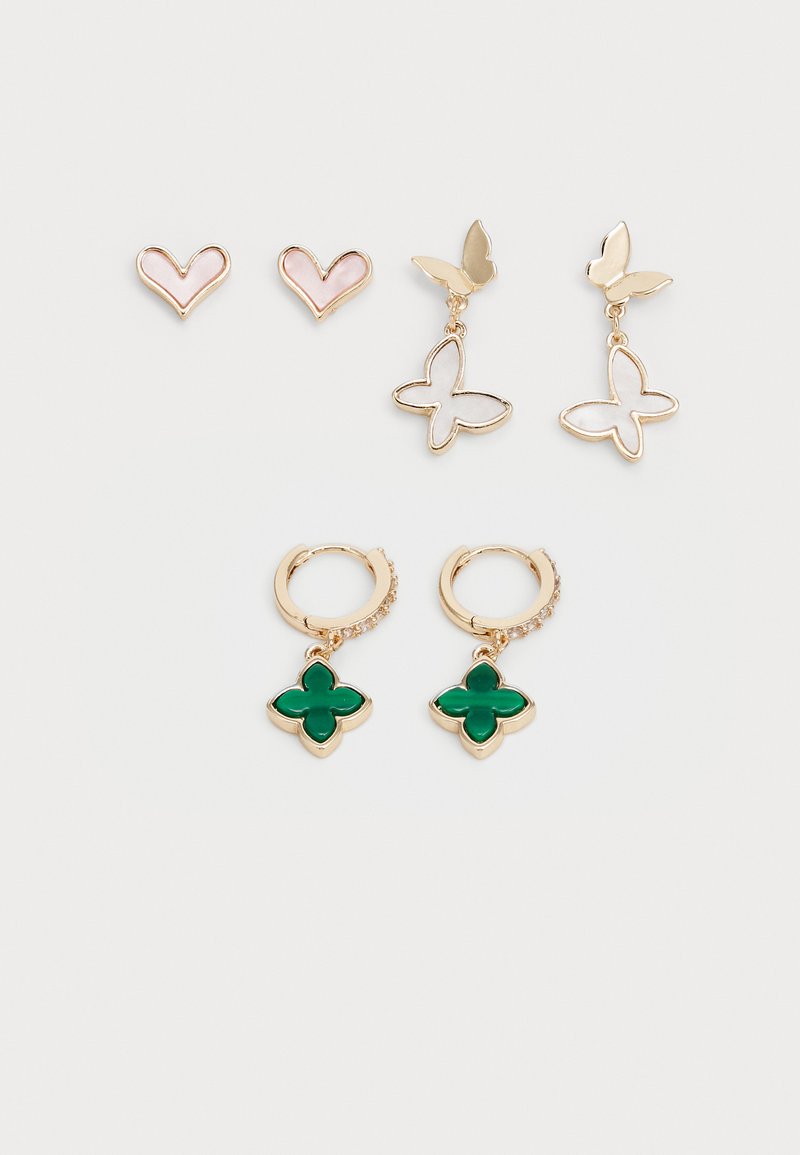 Gold-tone earrings set including two heart studs, butterfly drops, and green clover-shaped dangles with crystal accents on hoops.